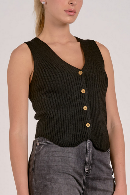 Close up of buttons on black knit sweater vest