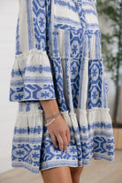 details on blue tiered mini dress with bell sleeves