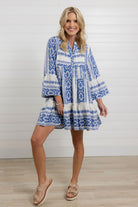 full view of the blue tiered mini dress with bell sleeves