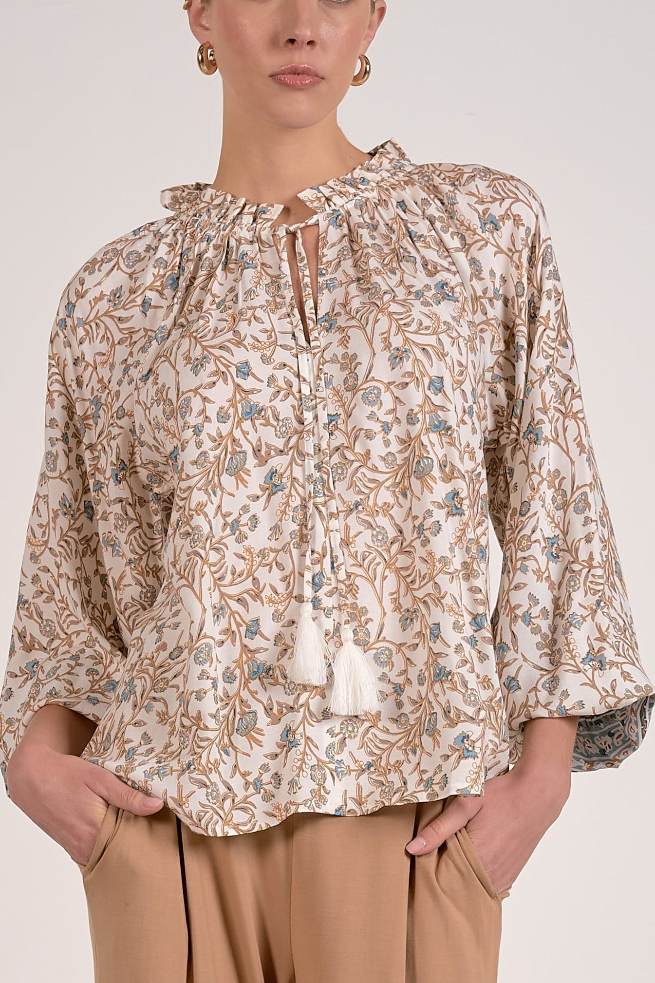 front view of blue floral print shirt with front tie tassels