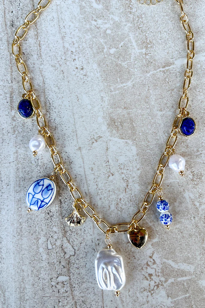 Blue and white porcelain charm necklace on gold chain