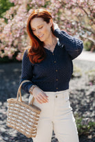 Woman on a walk wearing aPointelle Cardigan with Rose Buttons