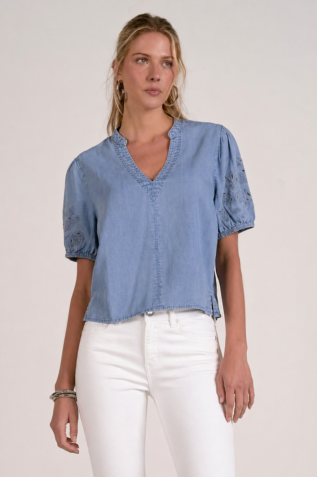 woman in chambray embroidered sleeve top with white denim