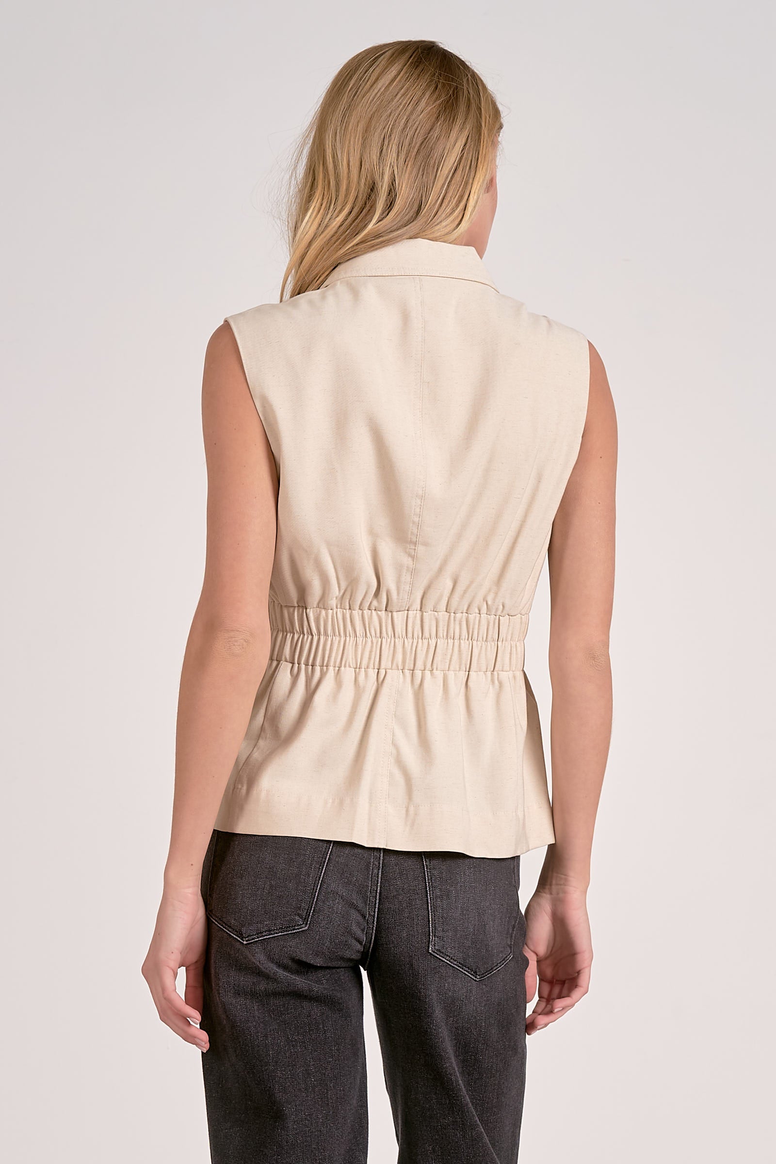 Cinched waist vest in natural color, back view