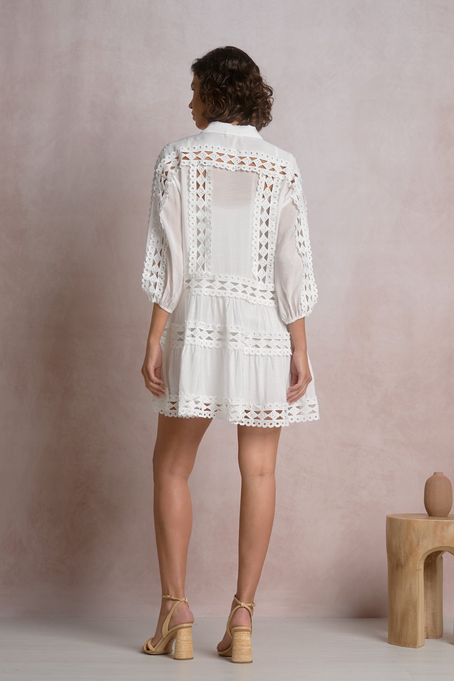 back of white tiered mini dress with crochet detailing lightweight vacation style