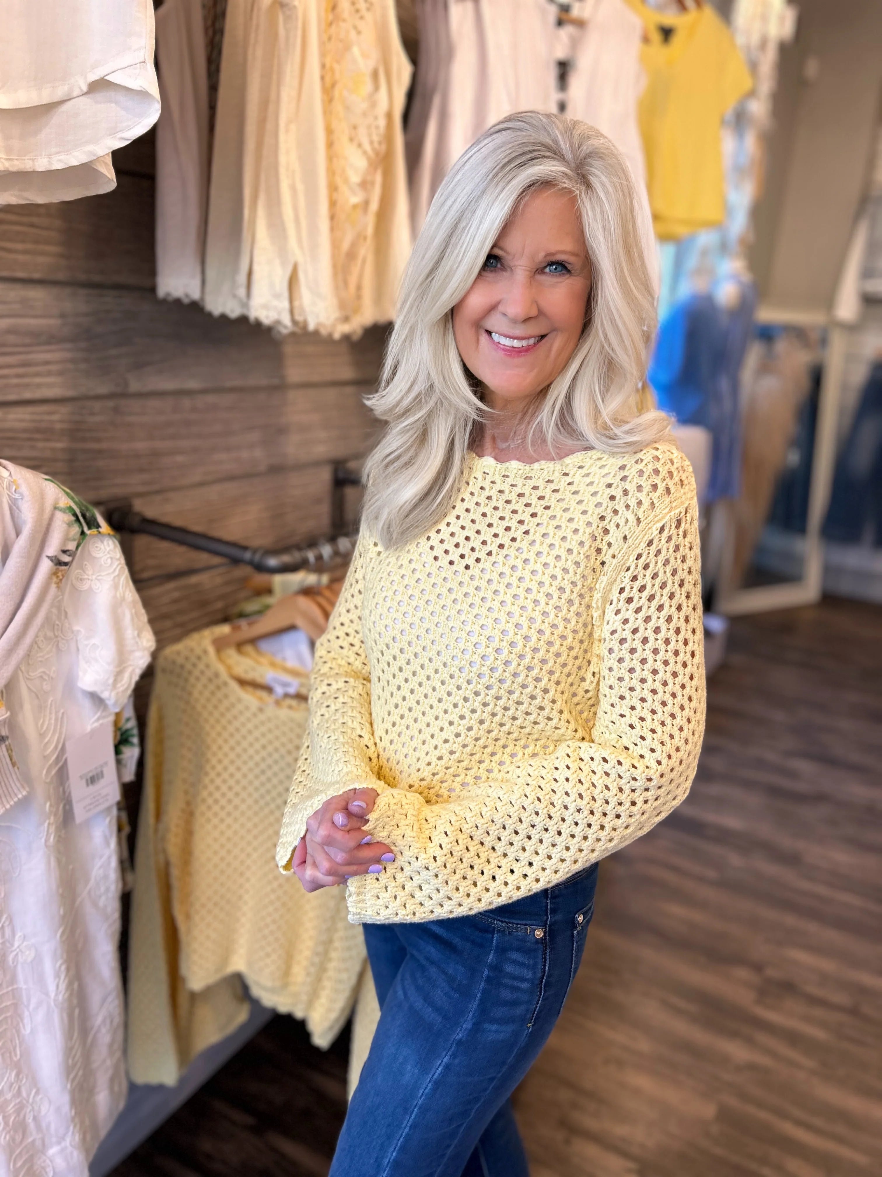 woman modeling the Crochet Open Knit Scallop Trim Sweater in butter yellow