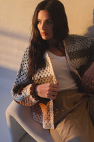 Woman modeling the crochet cardigan striped in beautiful fall colors