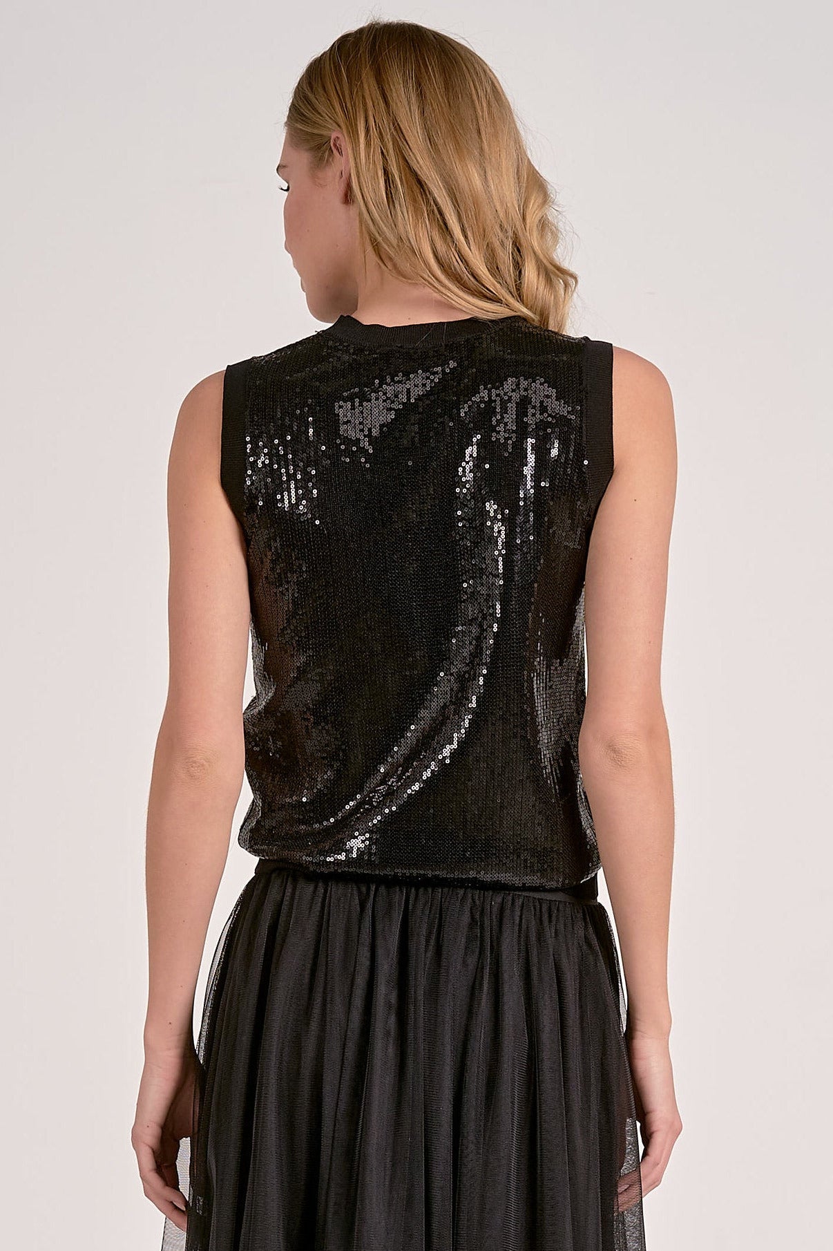 Woman modeling the back of the black sequin glitter tank top 