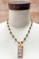 gold and bead necklace with earth tones rectangle pendant
