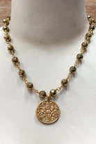 gold and bead necklace with solid coin pendant