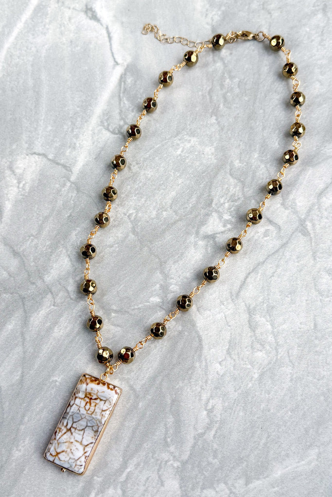 gold and bead short necklace with a rectangular earth tone pendant