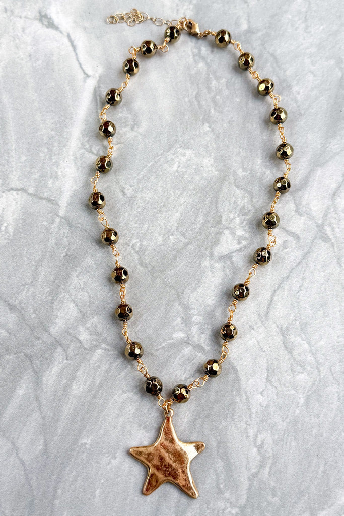 gold and bead short necklace with a solid star pendant
