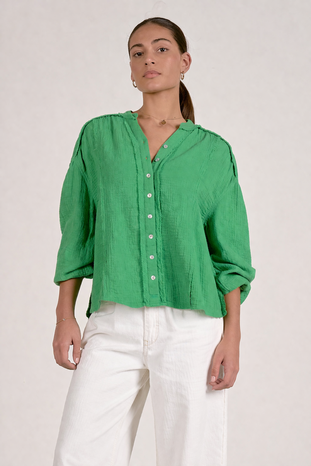 woman wearing kelly green gauze button front top
