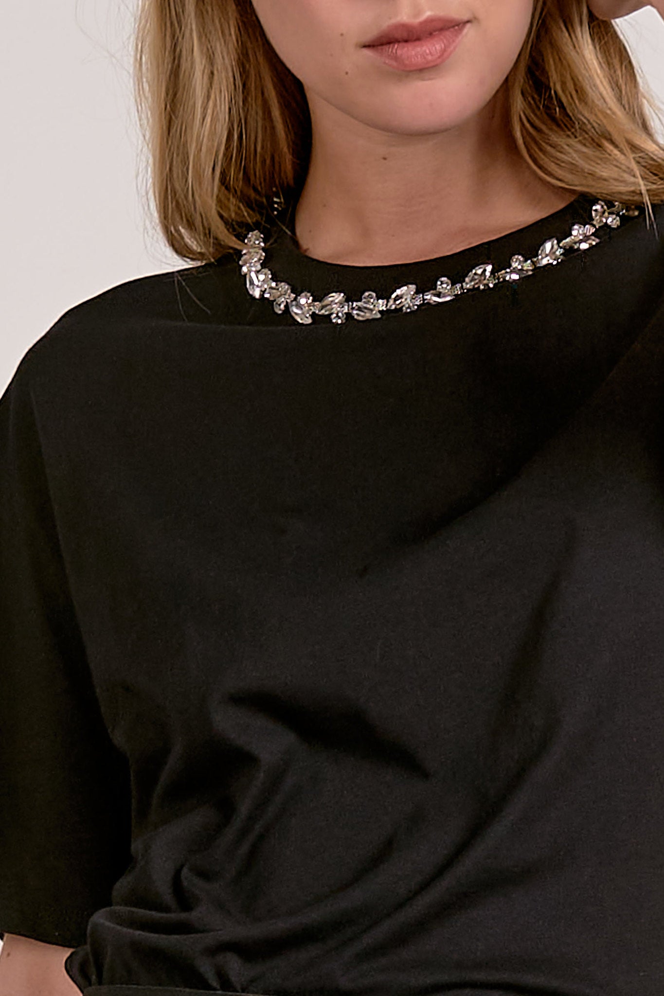 close up of model wearing The Soirée Tee in black with rhinestone embellished neckline from Mainstream Boutique Bloomington
