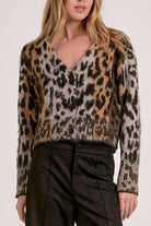 Model wearing Meet & Greet Eyelash Leopard Cardigan in fuzzy eyelash knit with leopard print and button-front closure from Mainstream Boutique Bloomington