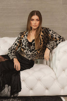 Model modeling Meet & Greet Eyelash Leopard Cardigan in fuzzy eyelash knit with leopard print and button-front closure from Mainstream Boutique Bloomington