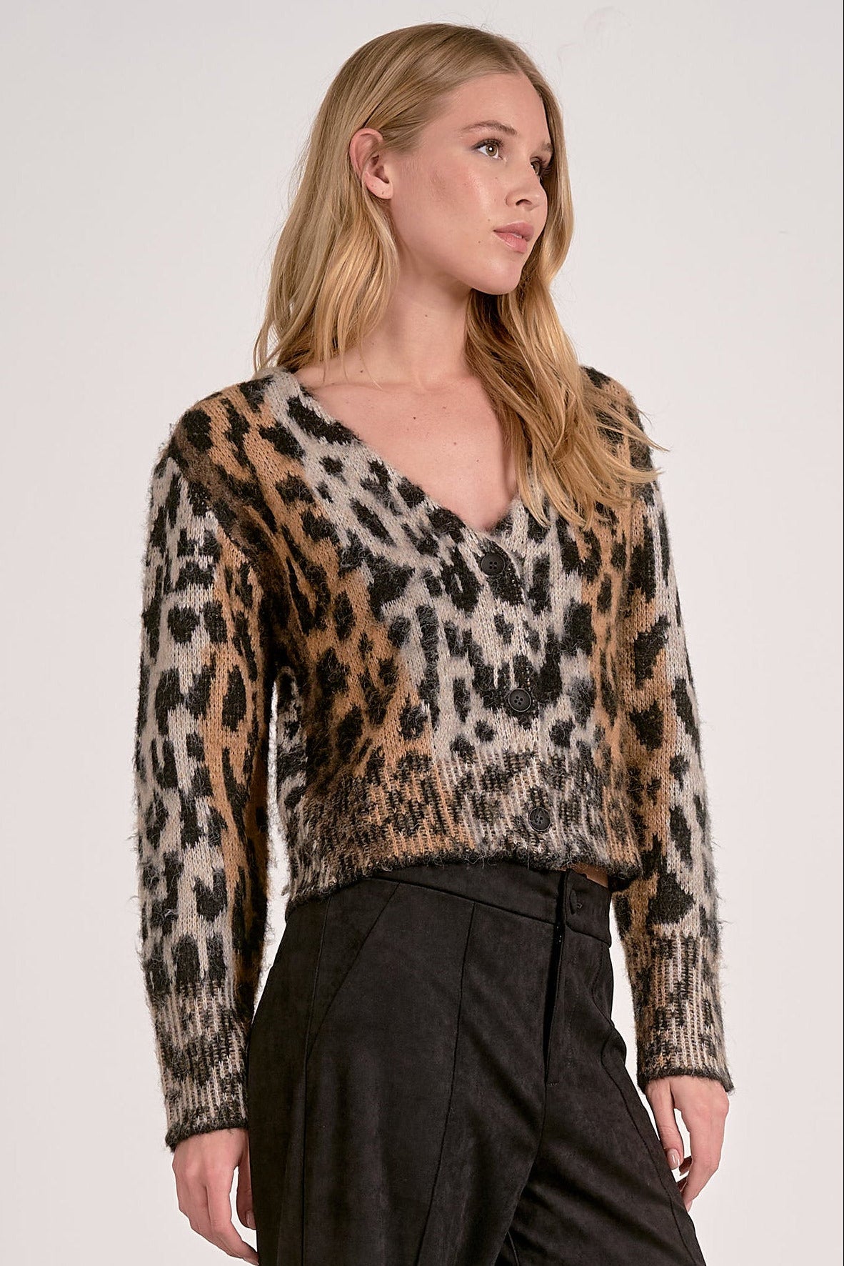 Model wearing Meet & Greet Eyelash Leopard Cardigan in fuzzy eyelash knit with leopard print and button-front closure from Mainstream Boutique Bloomington