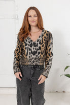 Woman modeling the Meet & Greet Eyelash Cardigan in leopard print from Mainstream Boutique Bloomington.
