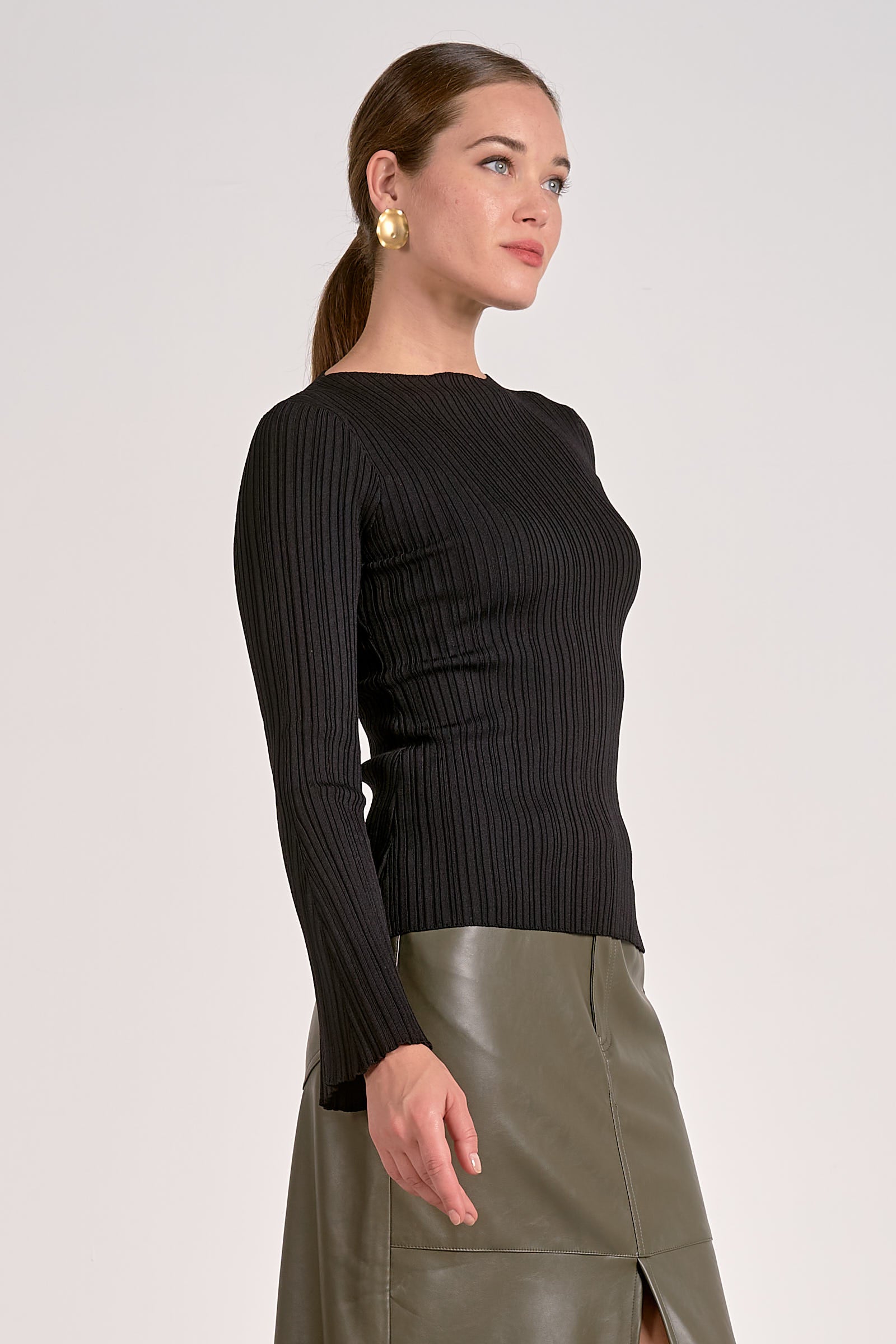 Woman showing the front and side of Black ribbed bell sleeve long sleeve top for women