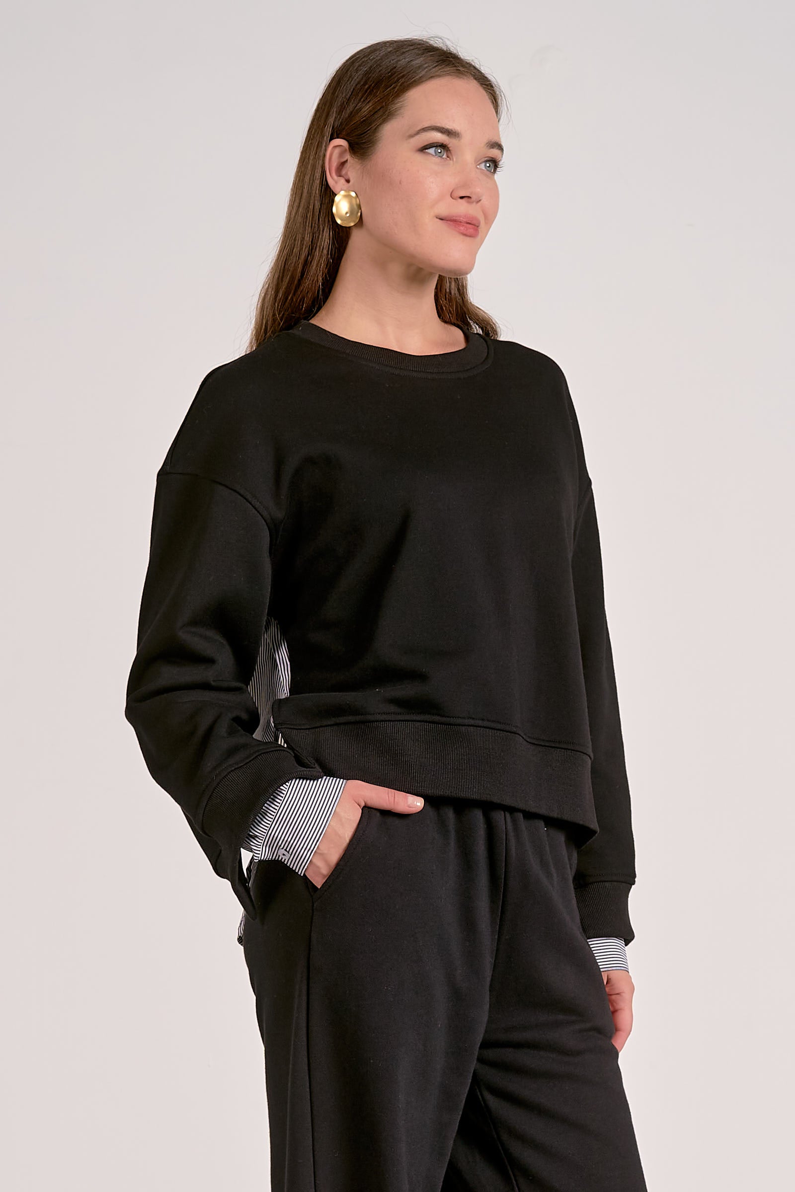 Black mixed media crewneck sweatshirt with striped woven back, side view