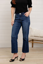 woman modeling front and side of mac and me barely boot denim in dark blue color 