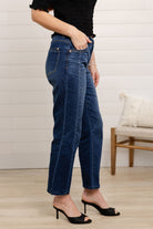 woman modeling side of mac and me barely boot denim in dark blue color with black top by Mac and Me 