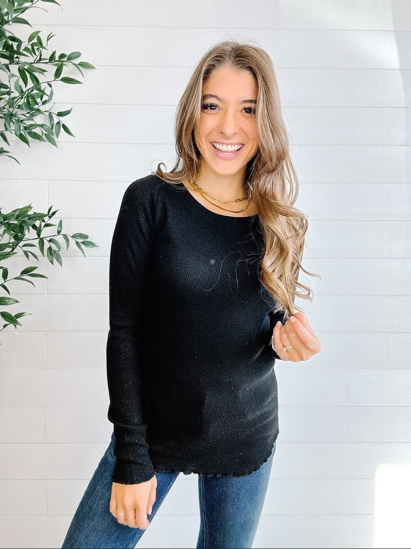 woman modeling the mac and me black ribbed waffle top with scalloped edges