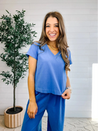 woman in meet and greet blue v neck top