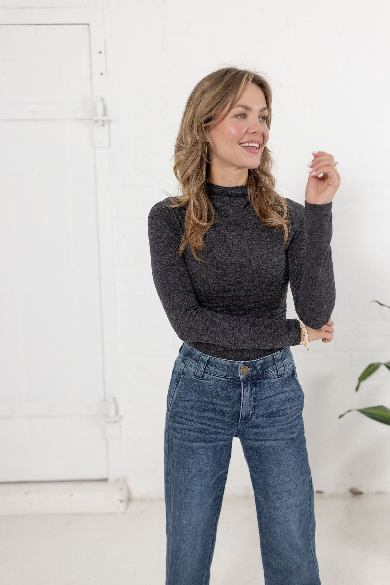 woman modeling Mock Neck Side Ruched Top in brushed grey with Mac and Me jeans.