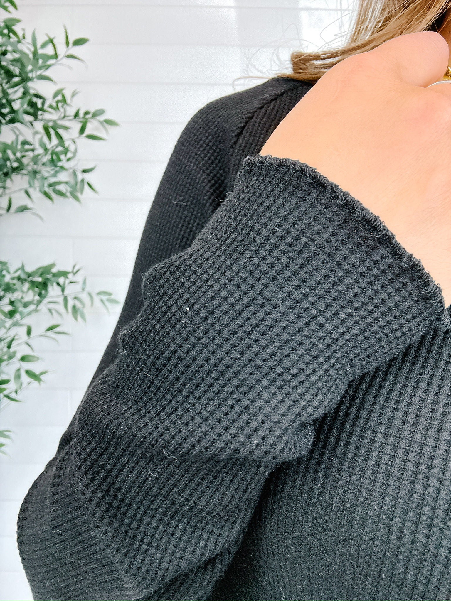 model showing the scalloped edges on the black mac and me ribbed waffle top