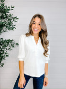Feminine white puff sleeve knit top paired with denim