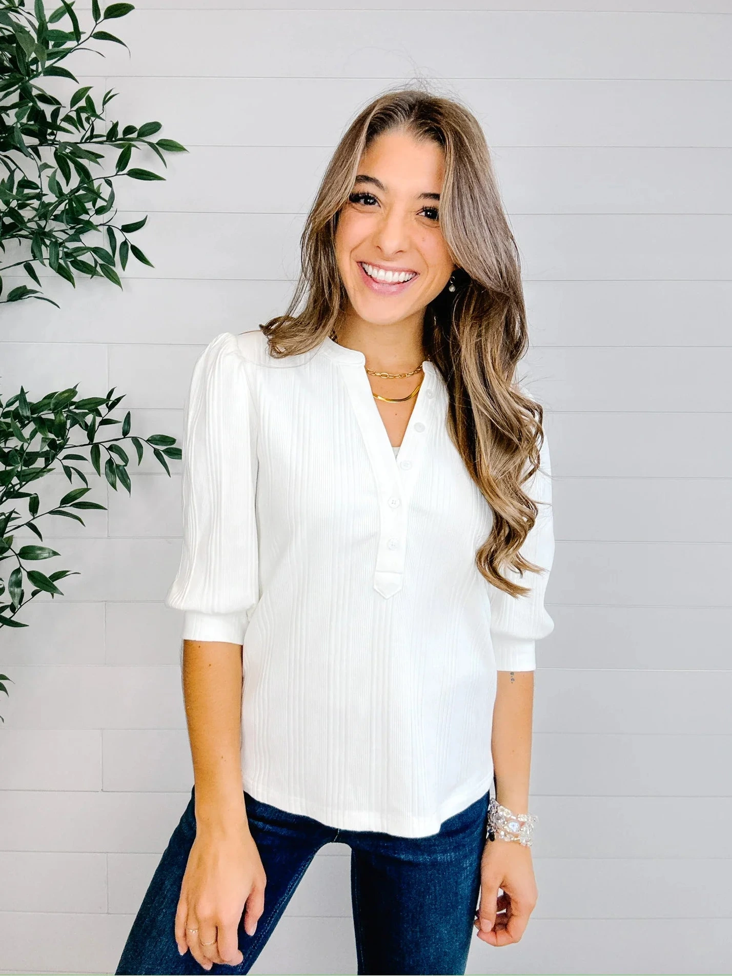 Feminine white puff sleeve knit top paired with denim