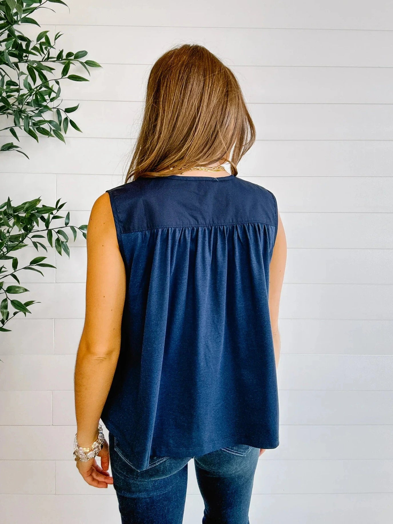 Back view of navy sleeveless gathered blouse for women