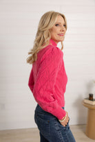 woman showing the side of the pink pointelle sweater by Mac and Me.