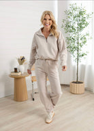 Woman walking with mac and me straight leg athleisure pants on.