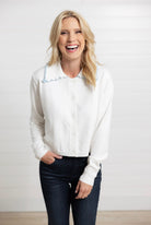 Mac and Me ivory ruffle collar sweater with blue lettuce trim worn with dark denim