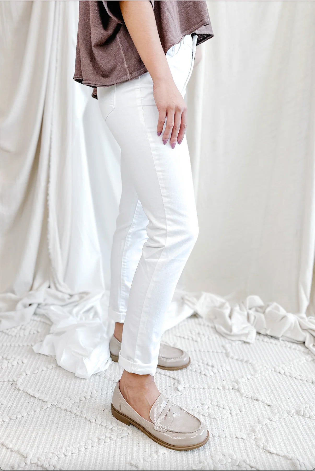 Cuffed white jeans styled for summer with relaxed straight leg
