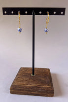 Small gold hoop earrings with blue floral porcelain bead drop