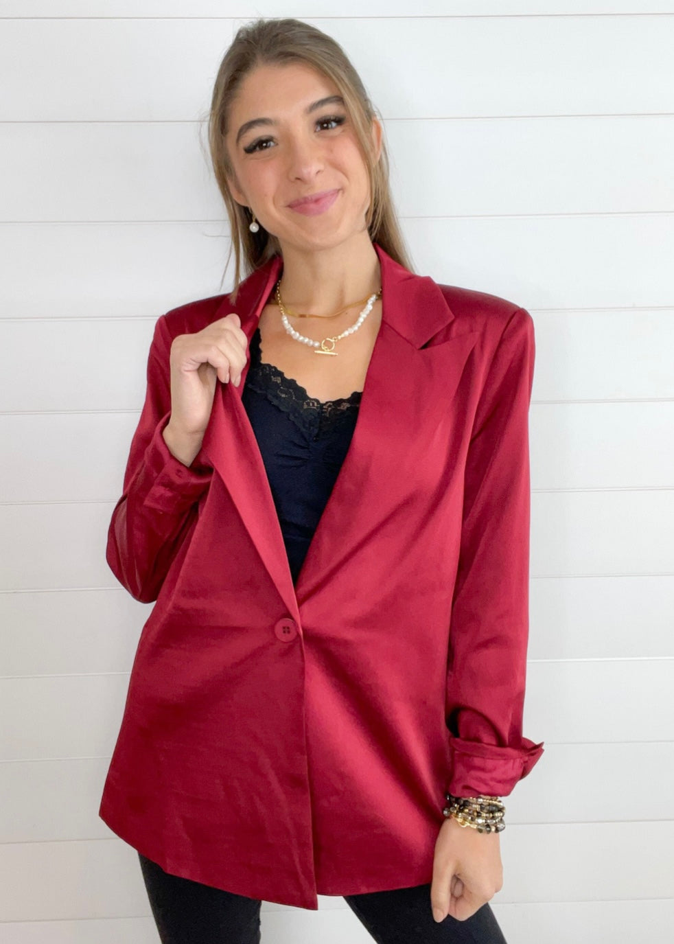 maroon satin tailored blazer on hanger with structured silhouette shown with black lace cami underneath