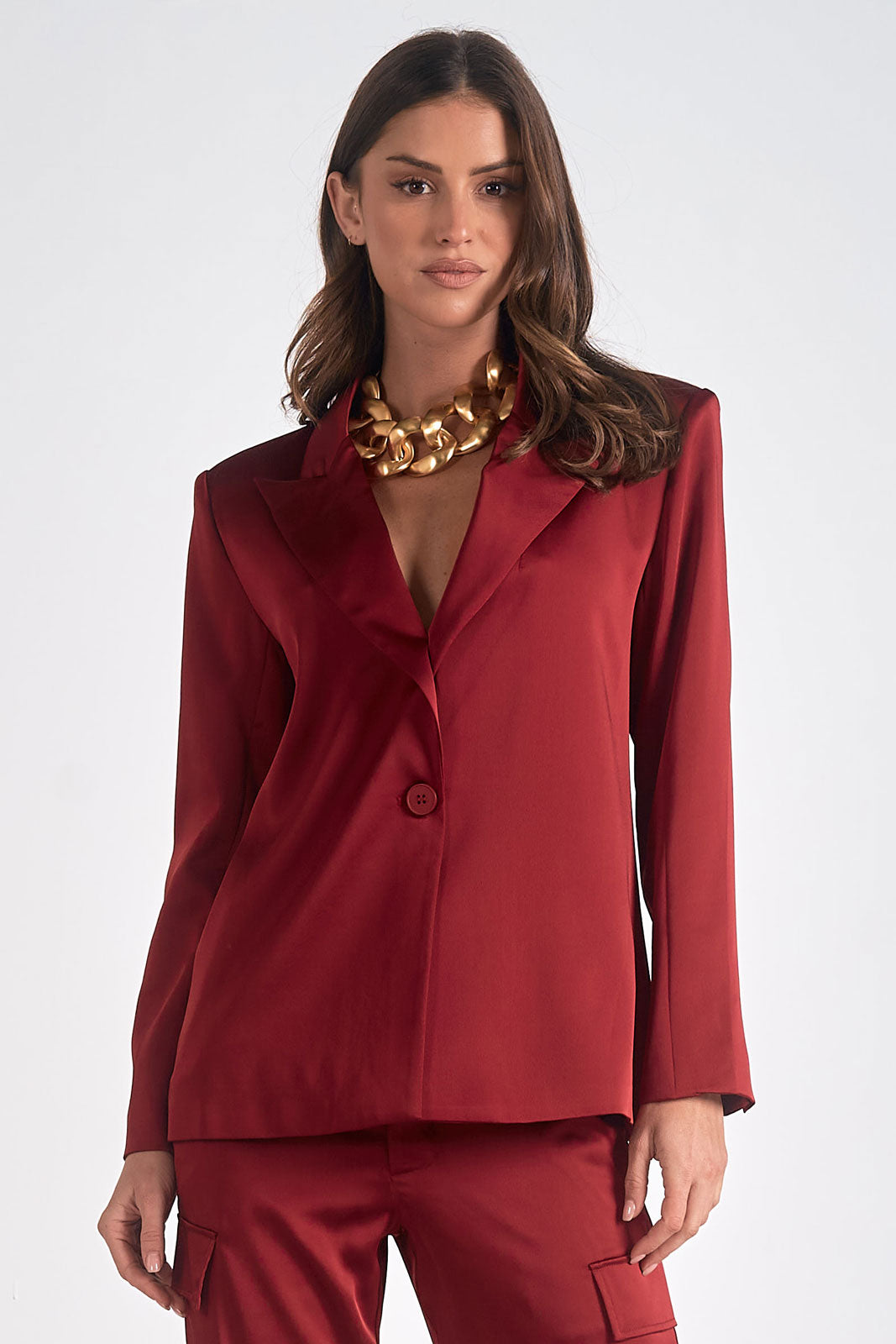 maroon satin tailored blazer on hanger with structured silhouette