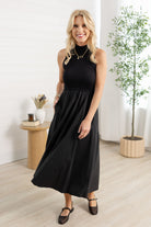 Woman modeling the black maxi mock neck sleeveless dress.