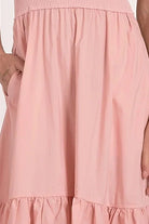 close up view of color and fabric on bottom of blush ribbed knit mixed media midi dress with tiered skirt and pockets