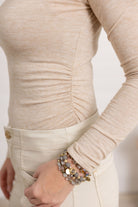 detail on the mock neck side ruched top by Mac and Me in the color brushed tan