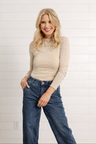 woman modeling the mock neck side ruched top in brushed tan by Mac and Me
