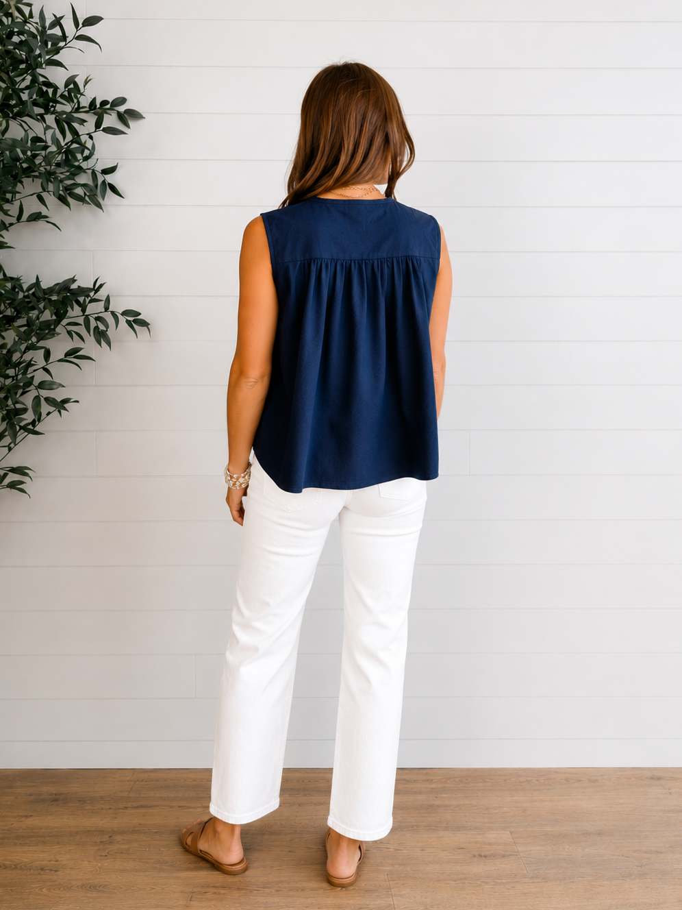 model showing back of sleeveless navy tie front top