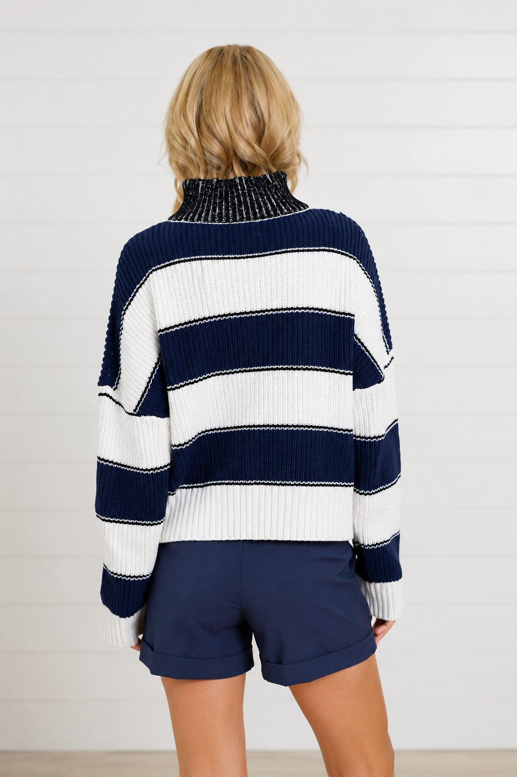 woman showing the back of navy and white stripe sweater 