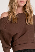 close up view of the dark chocolate off shoulder ribbed sweater with dolman sleeves