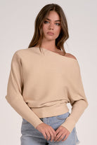 sand color off shoulder ribbed sweater styled with denim shorts