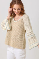 woman wearing a crochet sweater top in neutrals and a v neck on sale 