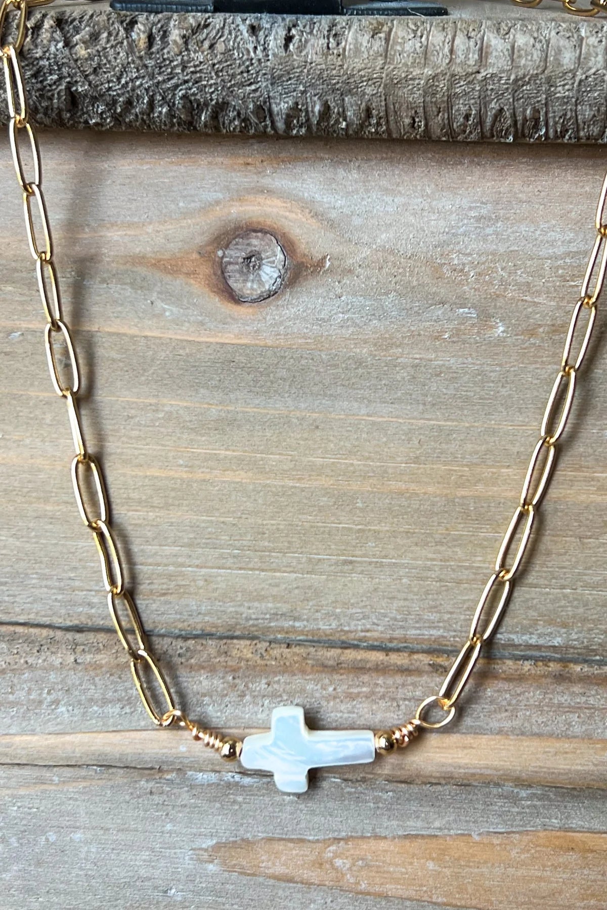 Gold chain necklace with sideways pearl cross pendant, delicate and perfect for layering